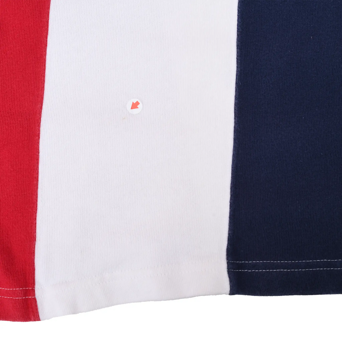 Close-up of lower red, white and navy panels with a faint spot marked on the white fabric