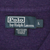 Close-up of Polo by Ralph Lauren neck label and size L tag inside purple sweater