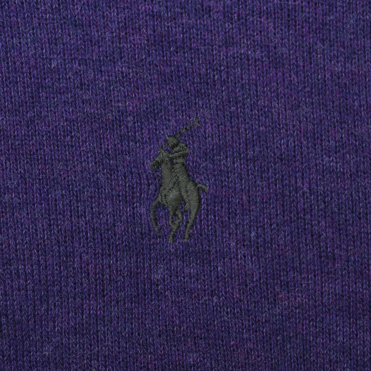 Close-up of dark embroidered Polo pony logo on purple sweater chest