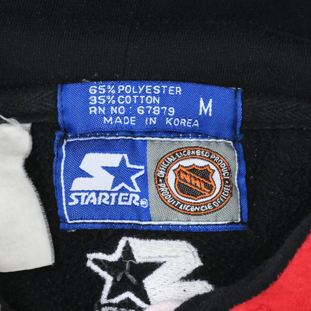 Starter medium label showing fabric blend, Made in Korea text, and NHL licensing patch