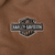 Close-up of embroidered Harley-Davidson bar-and-shield logo on brown hoodie chest
