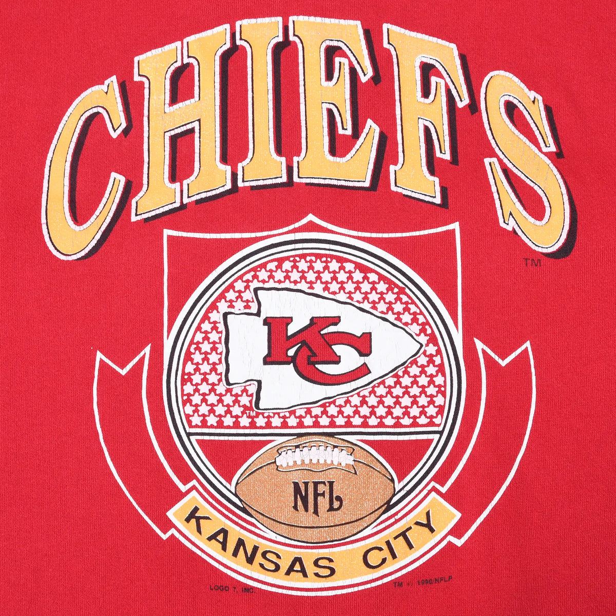 Close-up of Chiefs crest print with KC arrowhead, football, and Kansas City banner