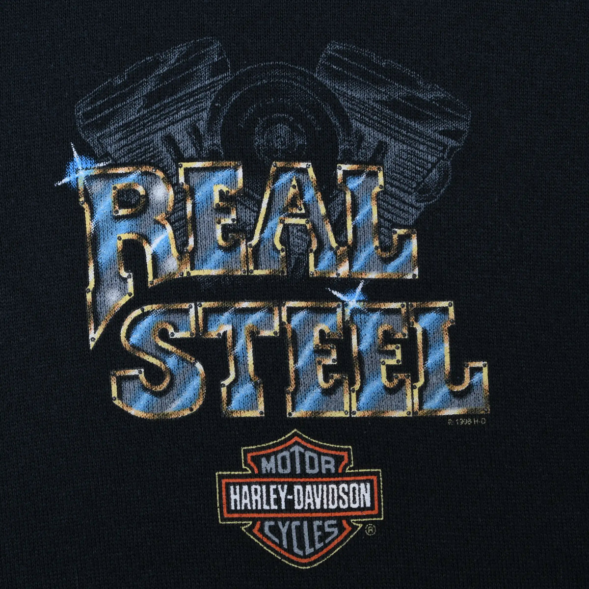 Close-up of Real Steel chest print with engine design and Harley-Davidson logo