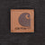 Close-up of tan Carhartt logo patch stitched onto dark brown fabric