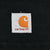 Close-up of Carhartt logo patch on black fabric