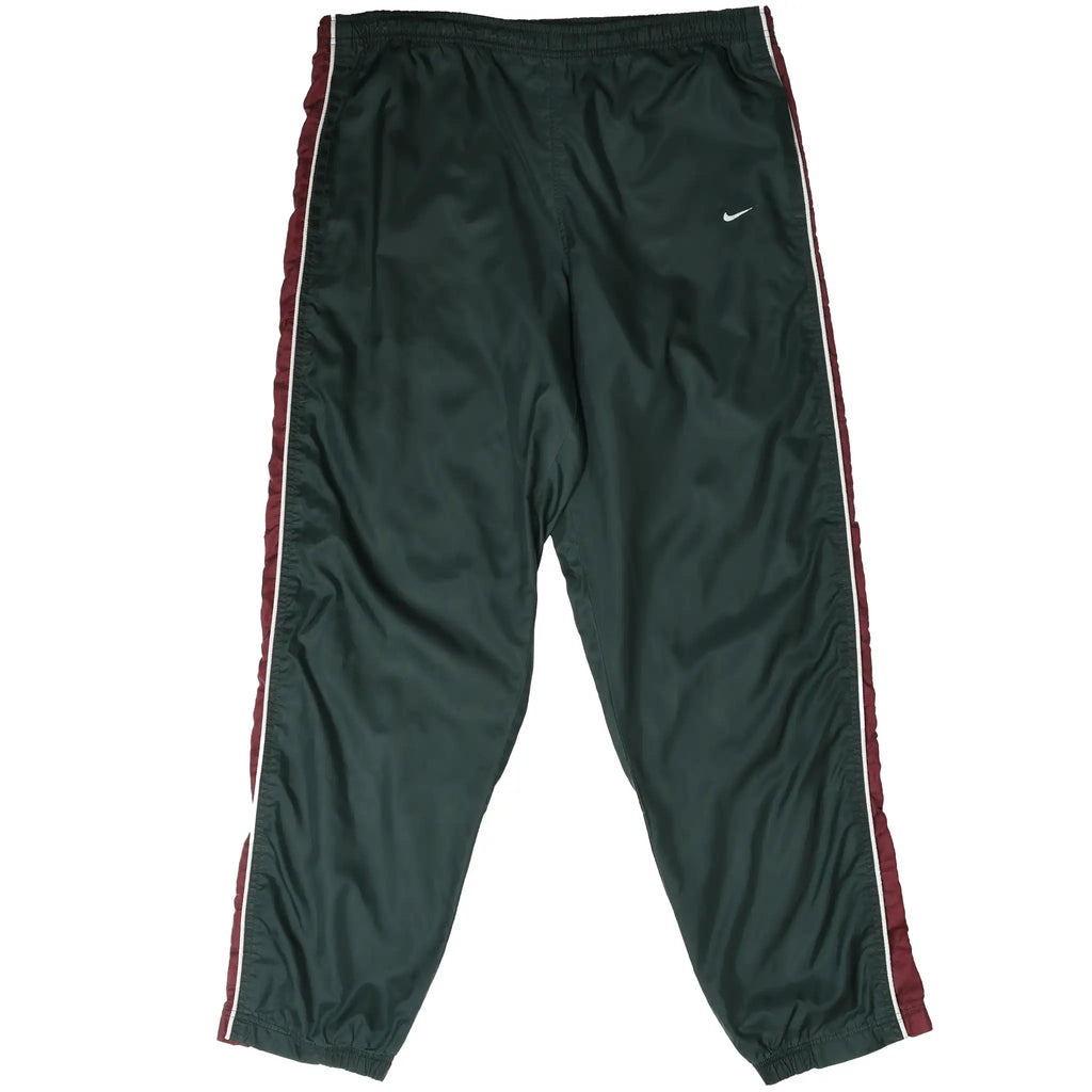 Front of dark green Nike track pants with burgundy side panels, white piping, and Swoosh embroidery