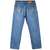 Back view of Levi's 505 blue jeans with two arcuate-stitched pockets and tan waistband patch