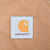 Close-up of Carhartt logo patch stitched onto brown canvas pocket