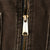 Close-up of brass-tone Carhartt zipper pull on dark brown vest