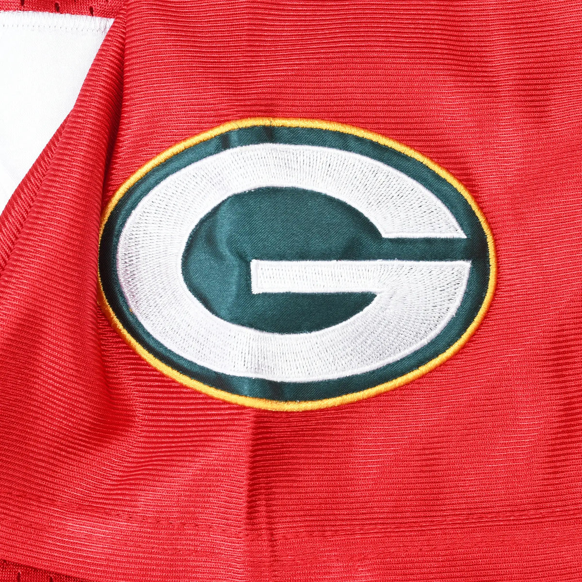 Close-up of embroidered Green Bay Packers logo patch on red jersey sleeve
