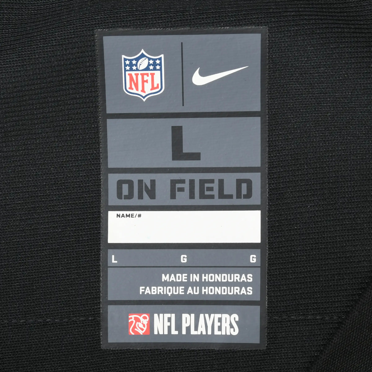 Close-up of Nike NFL On Field size L neck label on black jersey fabric