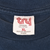 Tru-T XL neck tag on navy T-shirt showing preshrunk 100% cotton and made in El Salvador