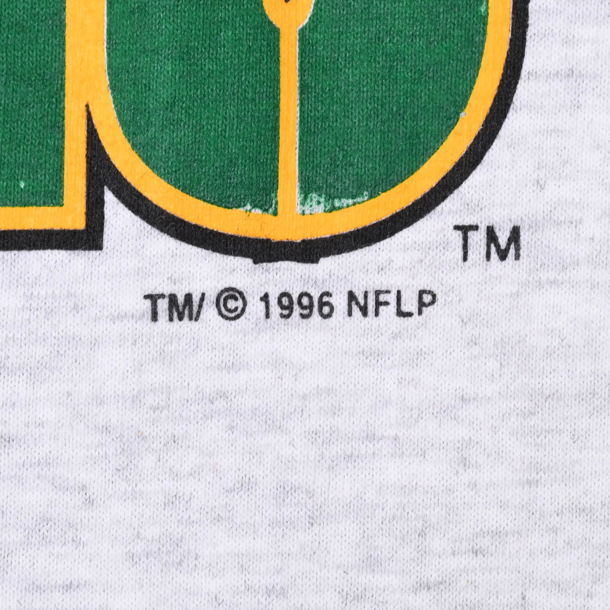 Close-up of TM and 1996 NFLP copyright text beneath the front print