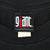 Close-up of Giant Merchandising neck label on black T-shirt