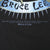 Close-up of Bruce Lee name banner and licensing text beneath the front graphic