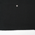 Close-up of black fabric near the bottom hem with a tiny marked spot