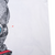 Close-up of white shirt area beside back graphic with arrow marking a small spot
