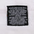 Reverse of black garment tag with Warner Bros. copyright and bilingual care instructions