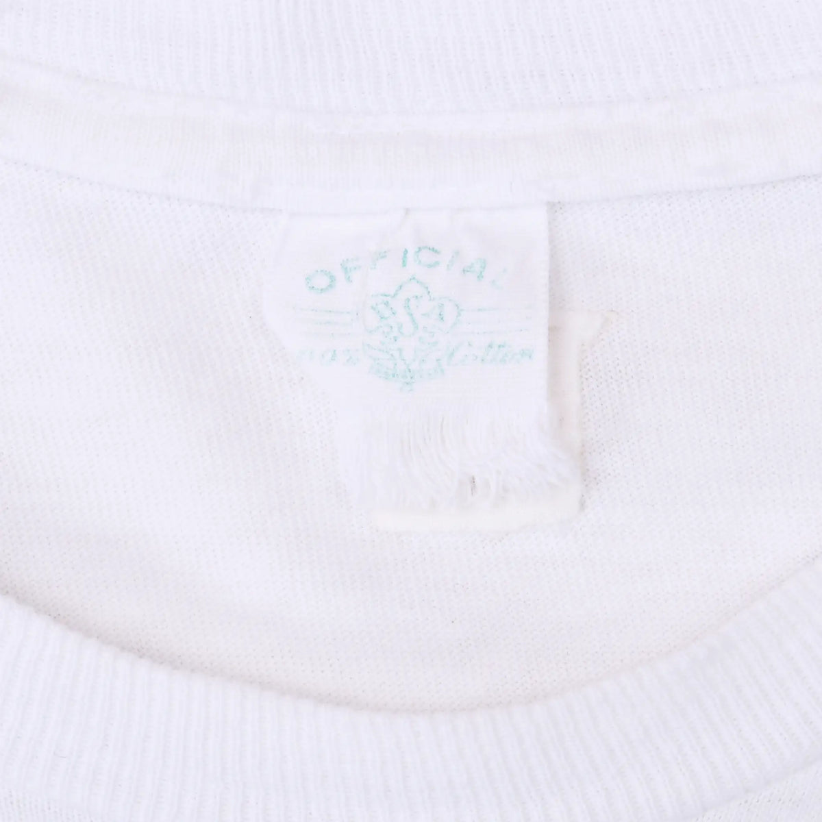 Close-up of the faded printed neck tag inside the white T-shirt collar
