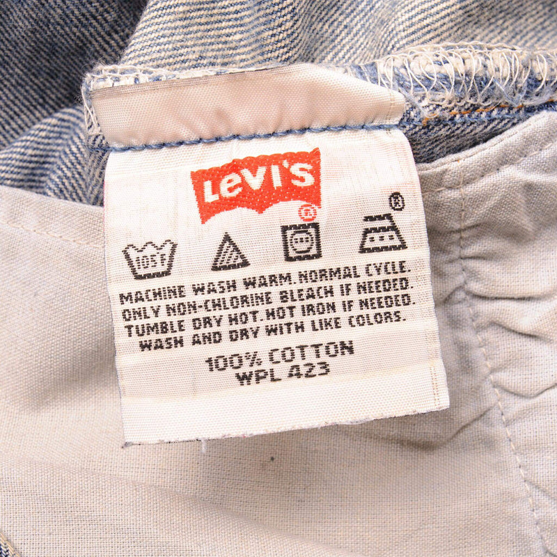 Beautiful Indigo Levis 501 Jeans 1990s Made in USA with a medium blue wash, a nice contrast of light and medium blue and some strong whiskers.  Size on Tag 34X36  ACTUAL SIZE 33X34  Back Button #977