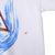 Close-up of small reddish mark beside the blue water print on white sweatshirt fabric
