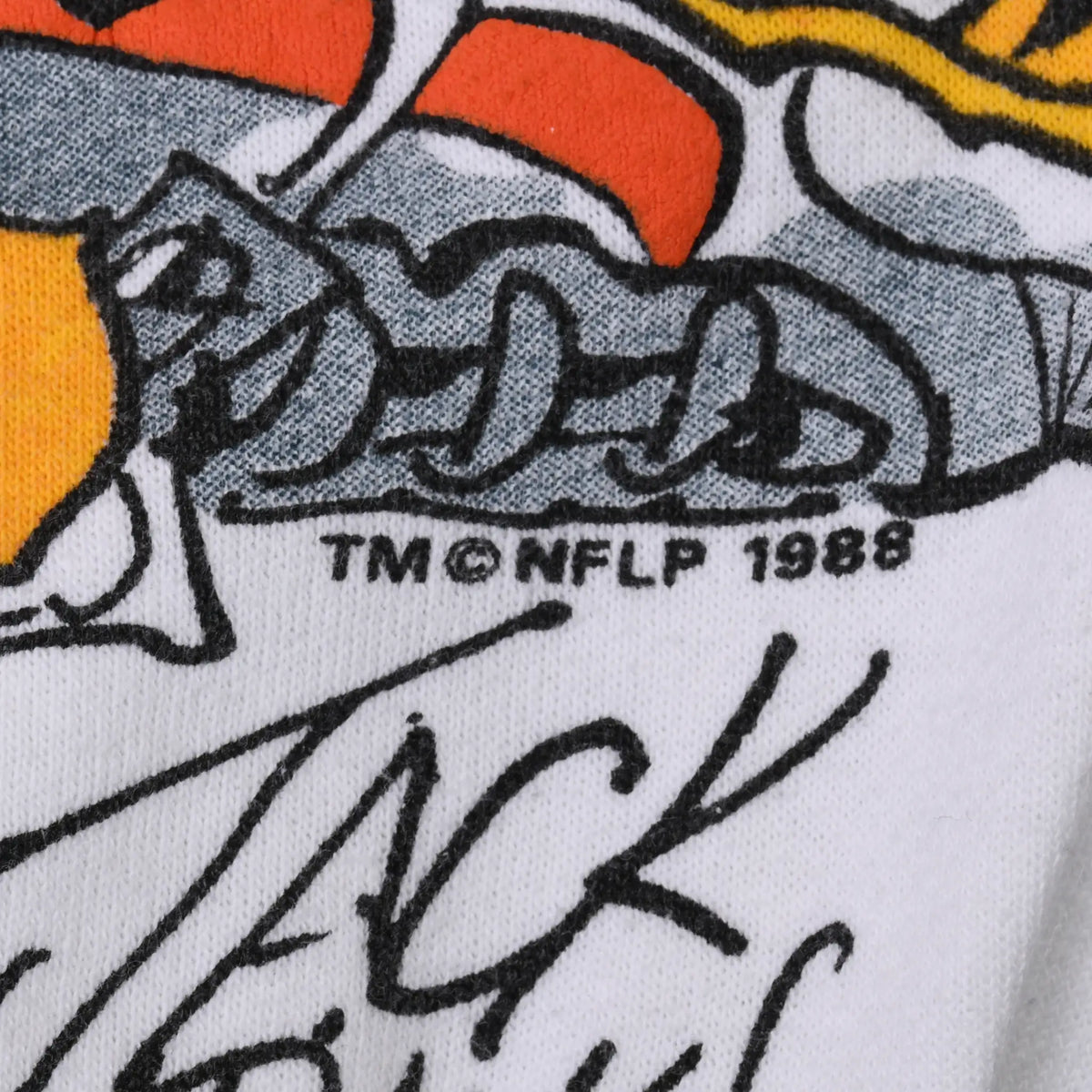 Close-up of printed artist signature and TM NFLP 1988 copyright detail