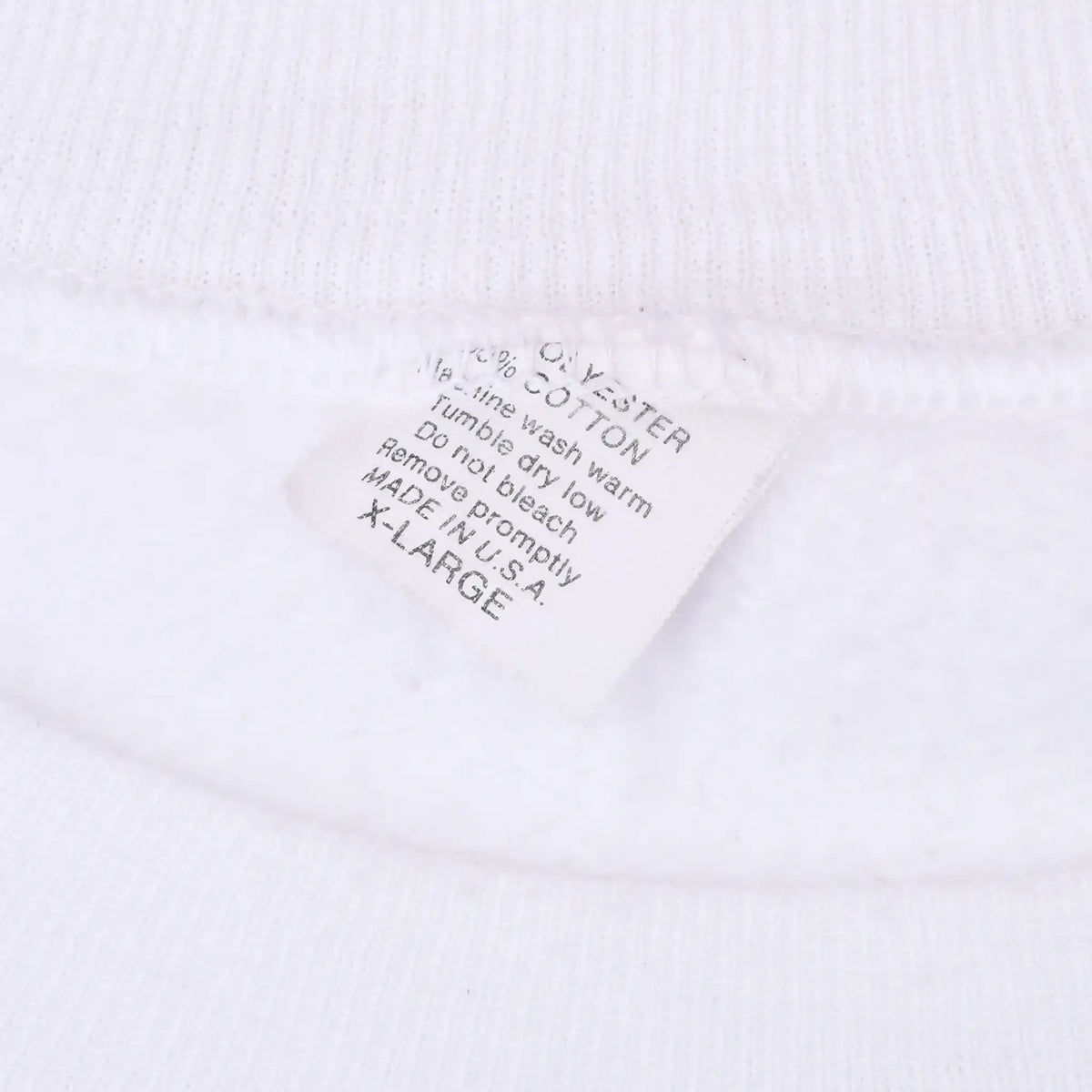 Close-up of sweatshirt care label marked XL, made in USA, beneath white ribbed collar