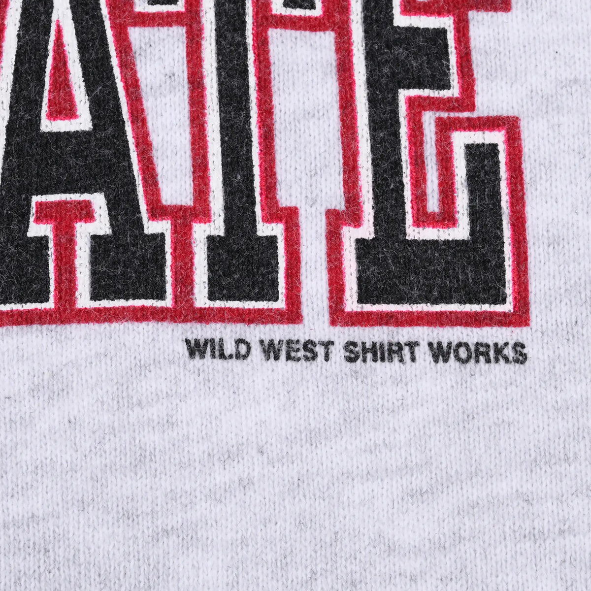 Close-up of Wild West Shirt Works maker mark beneath the printed sweatshirt graphic