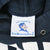 Close-up of Duke University Stores neck label with Blue Devil graphic inside navy hoodie