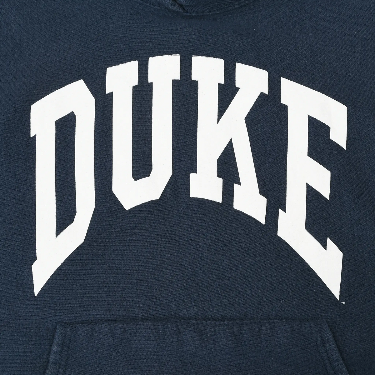 Close-up of white arched DUKE chest print on navy hoodie