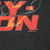 Close-up of Harley-Davidson logo print with orange flame accents and 2003 copyright mark