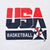Close-up of red, navy, and white USA Basketball chest graphic