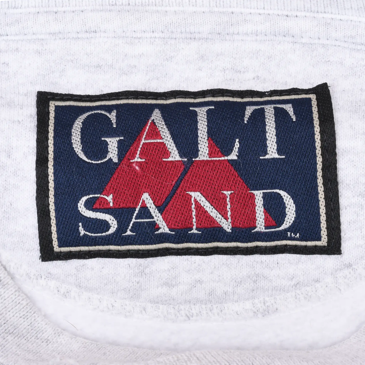 Close-up of Galt Sand woven neck label inside gray sweatshirt