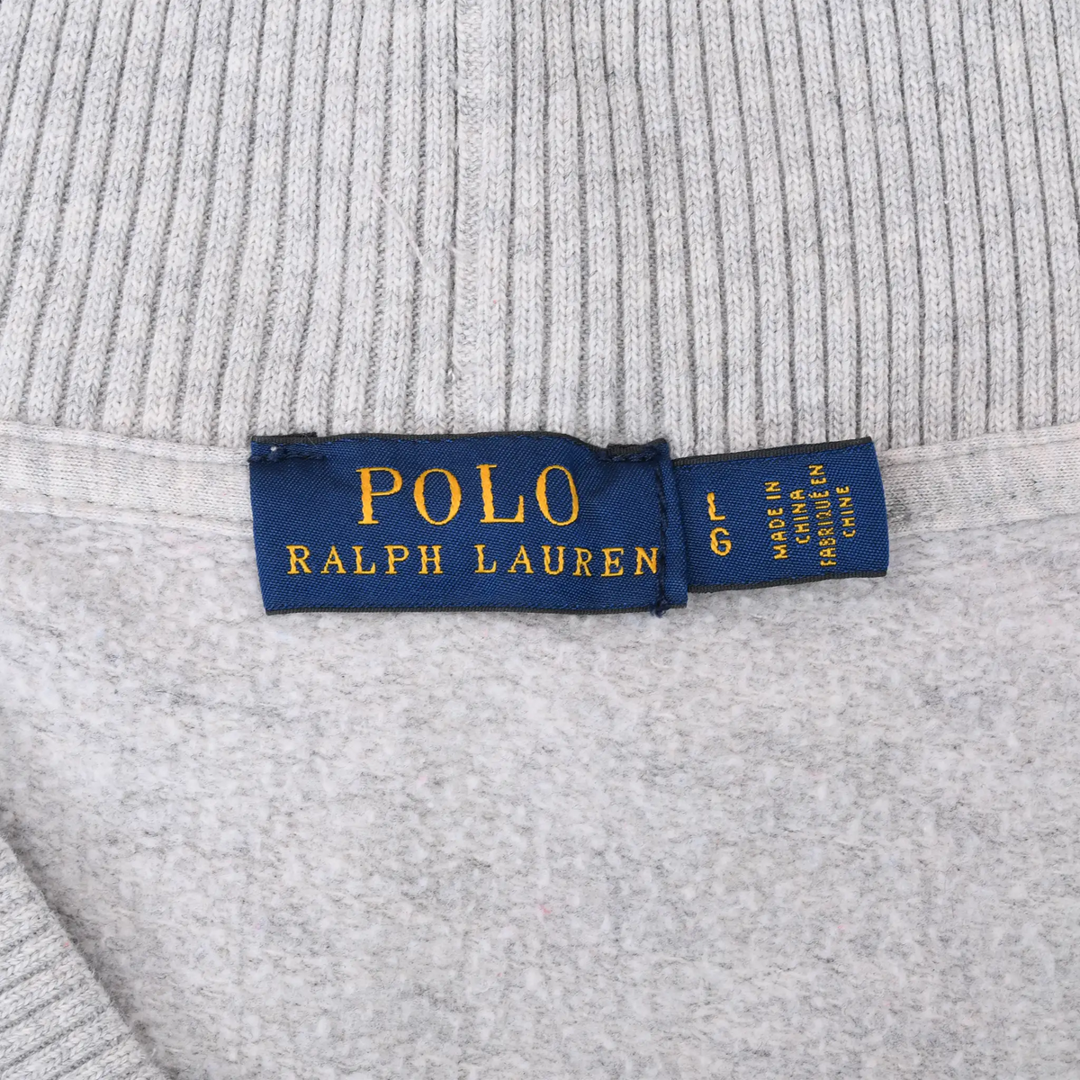 Close-up of Polo Ralph Lauren neck label and grey fleece lining