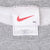 Nike sweatshirt neck tag with red Swoosh, XL marking, and Made in U.S.A. label