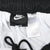 Interior waistband detail with Nike Swoosh label, care tag, white lining, and black drawcord