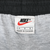 Close-up of Nike size L waistband label with red Swoosh