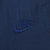 Close-up of tonal blue Nike Swoosh embroidery on navy track pants
