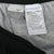 Nike interior care and manufacturing labels at the waistband of black track pants