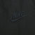 Close-up of black Nike Swoosh embroidery on track pants