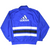 Back of royal blue adidas windbreaker with large white logo and black-and-white horizontal stripes