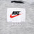 Nike neck label with black logo, red Swoosh, and Large size marking on gray lining