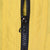 Close-up of black front zipper and pull on yellow Nike windbreaker