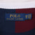 Close-up of Polo Ralph Lauren neck label marked 2XB 26 beneath the white collar