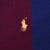 Close-up of yellow Polo pony embroidery on burgundy and navy striped fabric