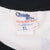 Close-up of Chalk Line neck tag beneath the black ribbed sweatshirt collar