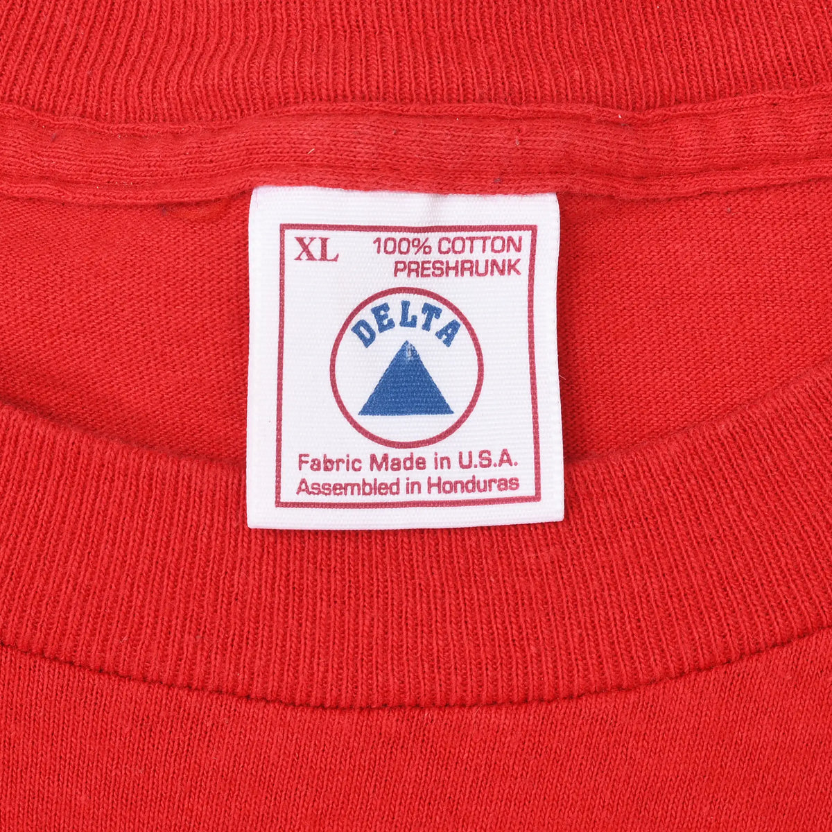 Delta XL neck tag stating 100% cotton preshrunk, fabric made in USA and assembled in Honduras