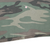 Close-up of woodland camouflage fabric and bottom hem with a small spot marked
