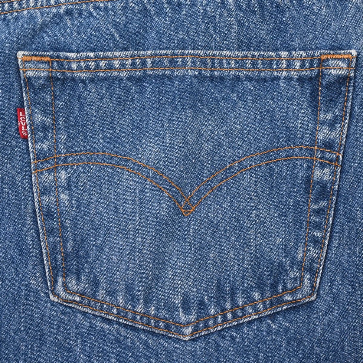 Levi's jeans back pocket with orange arcuate stitching and red tab