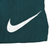 Close-up of large white Nike Swoosh print on green swim trunks